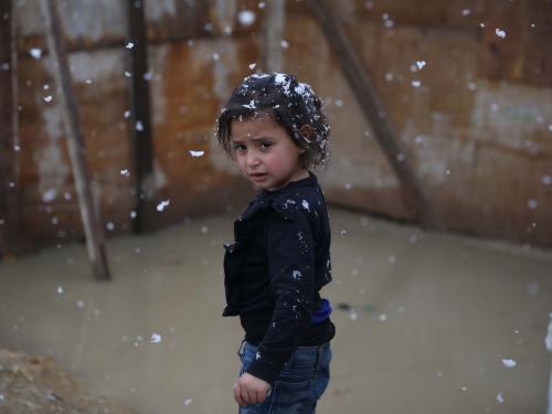 Aisha stands in the snow in front of her flooded tent in an informal refugee settlement in Lebanon’s Bekaa Valley, which is home to more than 215,000 Syrian refugees.