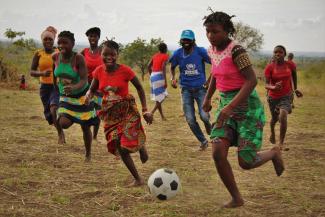 Displaced and host community girls play football in Cabo Delgado, Mozambique as part of the World Refugee Day celebrations.
