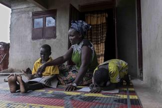 Rose helps her son and niece with their studies at their home in Magwi village, South Sudan. After returning from a decade as a refugee in Uganda, she founded Magwi’s Women’s Association, which now has 35 members.