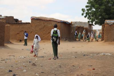 Secondary school students walk home in Abu Shouk camp for internally displaced people in North Darfur, Sudan.
