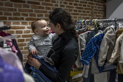 holding a child in a clothes shop