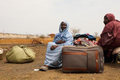 Lushia has just arrived with her husband at the UNHCR transit centre, near the Joda border point in Renk, South Sudan. UNHCR buses take the most vulnerable new arrivals from the border to the center. They fled the civil war in South Sudan for Khartoum and were living there for eight years.  © UNHCR/Charlotte Hallqvist