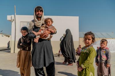 a father standing with his children.