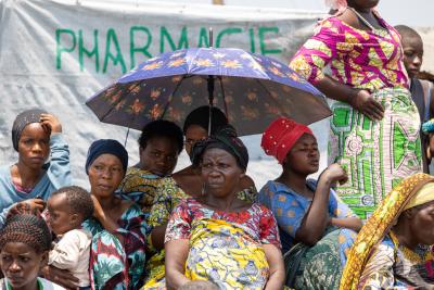 Women siting under un umbrella. 