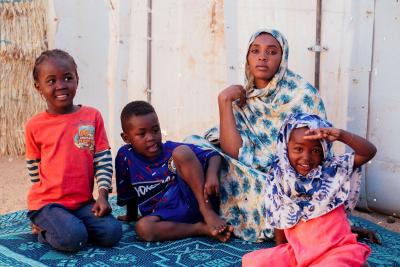 woman and children sitting in the shadow