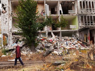 woman walking in front ruins