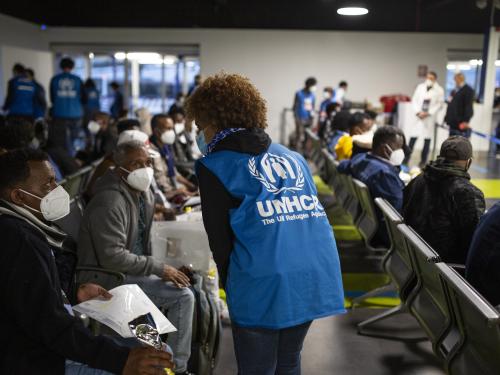 UNHCR staff greeting asylum-seekers at the airport