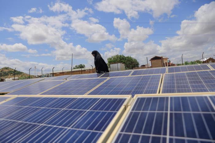 Woman fixing solar panels