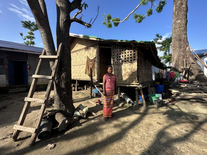 Ma Soe Yai stands in front of her longhouse shelter shared with other families. Their roof leaks whenever it rains. Residents of Ngai Sa Rai Monastery worry about the damaged state of communal shelters and facilities. © UNHCR/Reuben Lim Wende