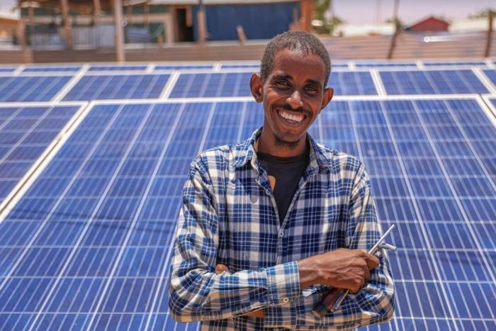 man standing in front of solar panels