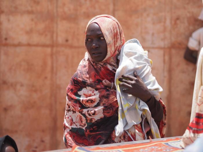 woman carrying a baby born