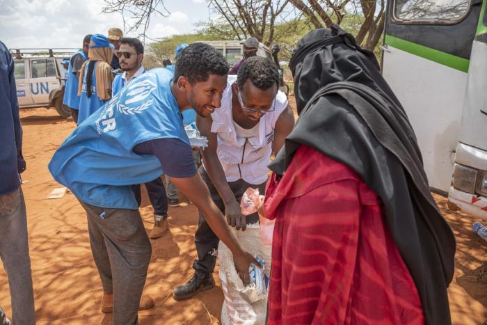 staff helping a woman receiving assistance