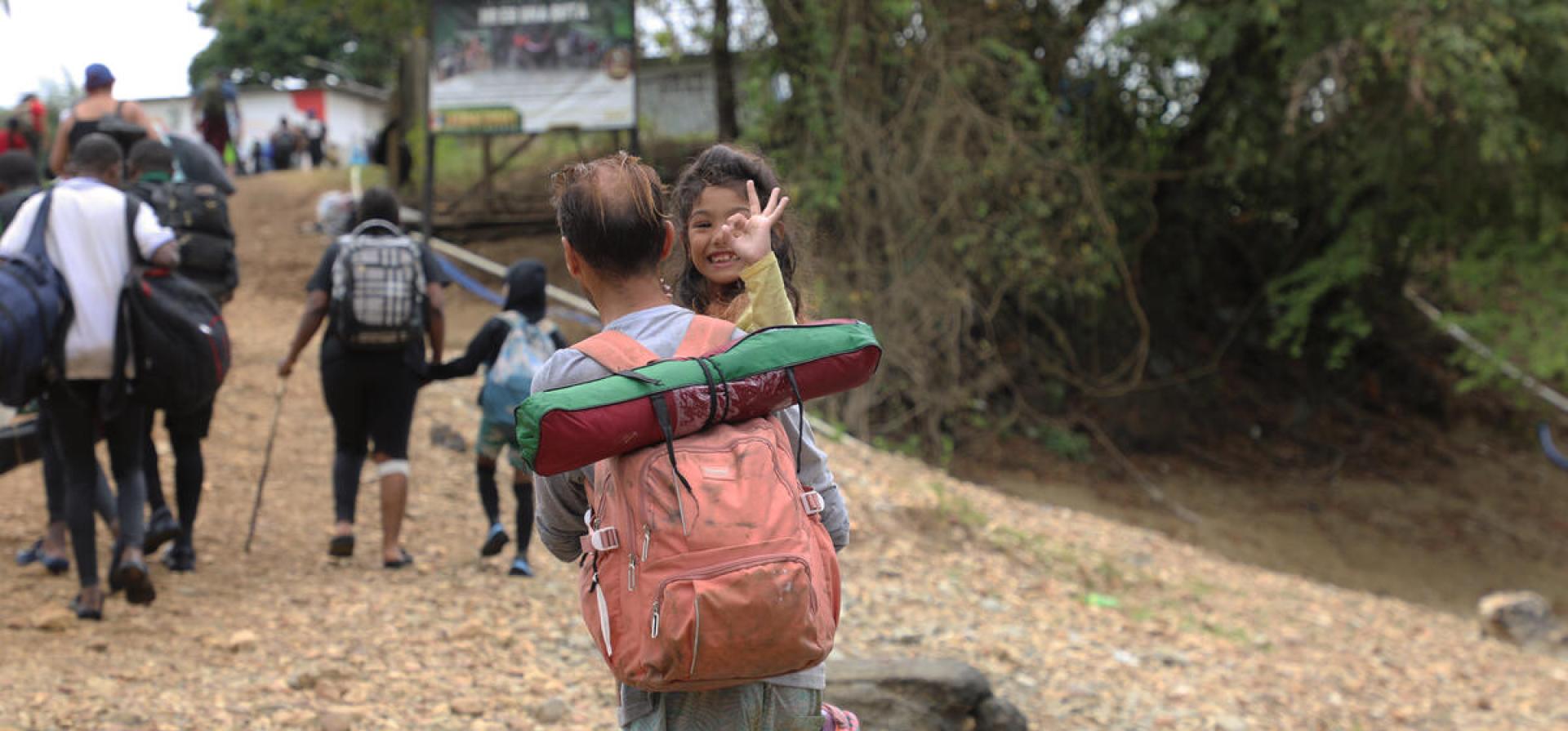man carrying her daughter