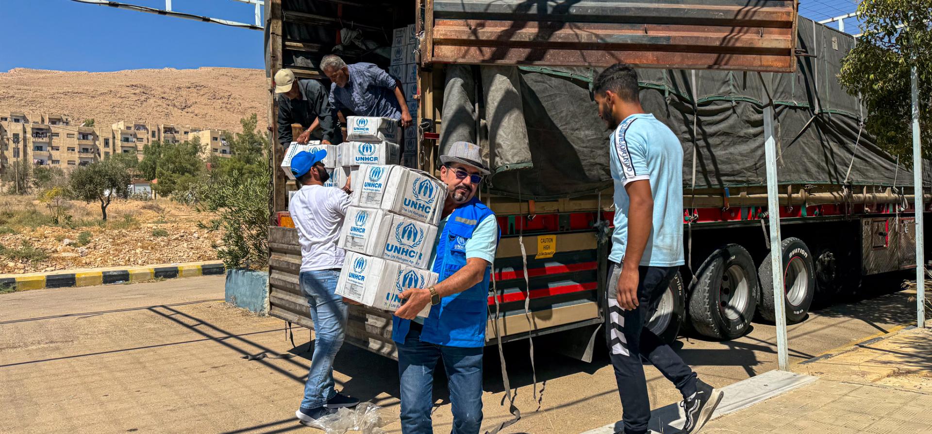 People unloading a truck
