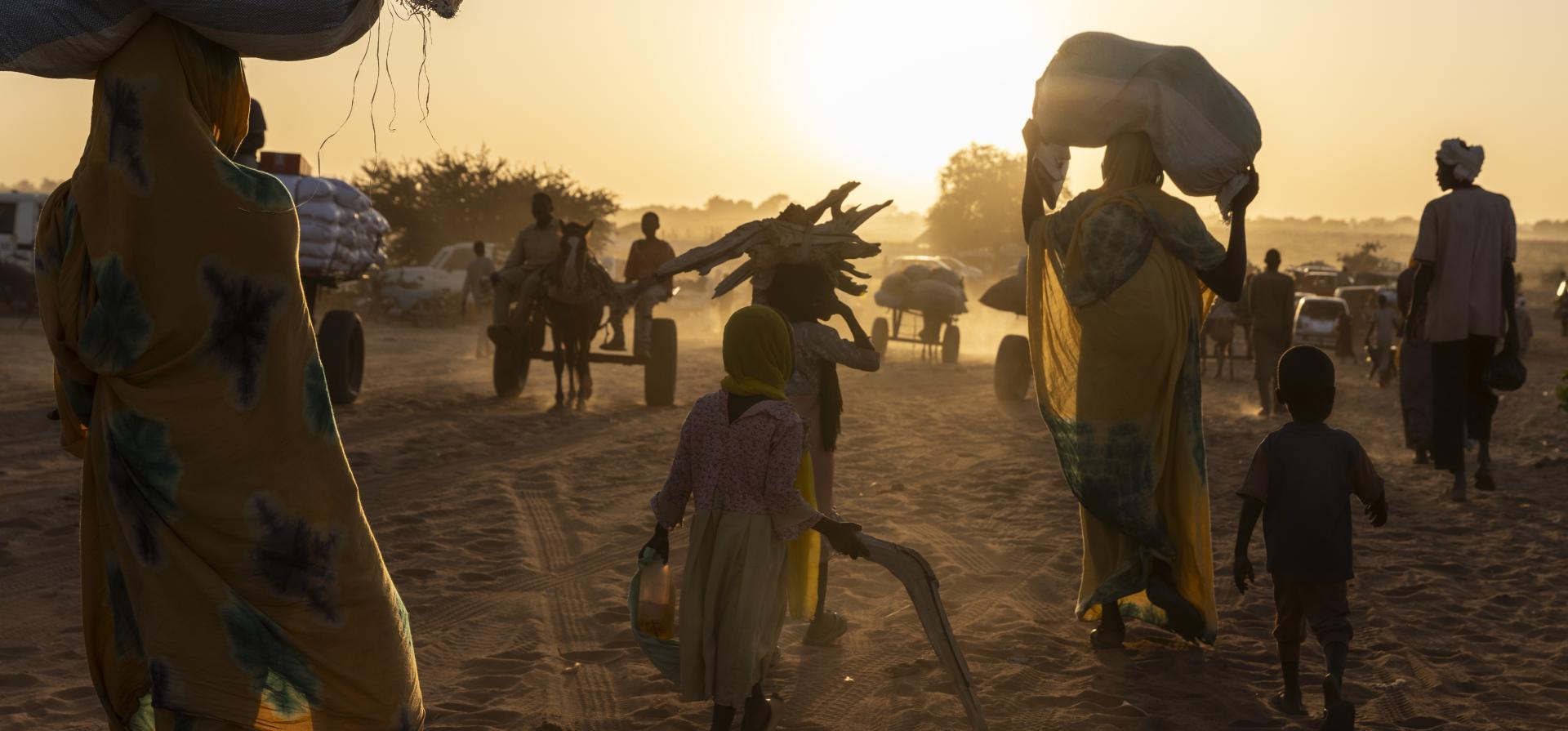 people fleeing during a sunset