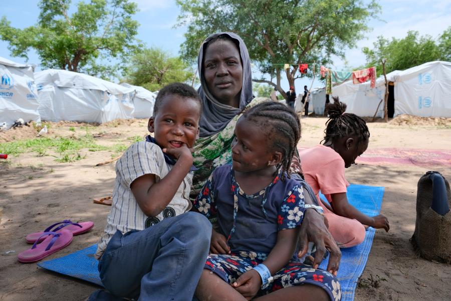 Widowed Sudanese refugee Fatma and her children sit near community shelters at the UNHCR-supported Korsi site, near Birao, Central African Republic. The family is among more than 1,200 Sudanese refugees who have settled at the newly established site after fleeing the conflict at home. © UNHCR/Josselin Brémaud