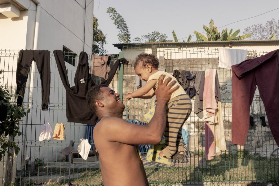 Saior Suarez, 33, a Colombian asylum seeker who left his country unable to sustain his family due to the rise of the prices, plays with his 1-year-old son Liener at the UNHCR-supported J’tatic Shelter in the Pakalna neighborhood of Palenque, where they receive food, accommodation, primary medical care, and legal assistance.