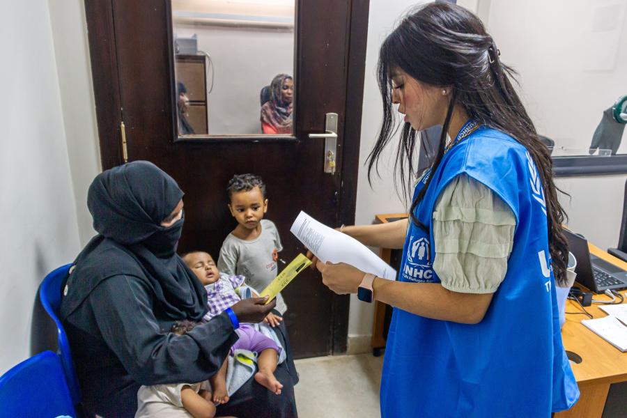 Nour Behairi, UNHCR Registration Assistant, registers a Sudanese family after completing their registration process in Cairo. After fleeing Sudan due to violence, Rania* (35) approached UNHCR Registration Center in Cairo, together with her three children, Khalid* (3), Hamid*, and Naglaa * (0), where they were registered as asylum seekers.