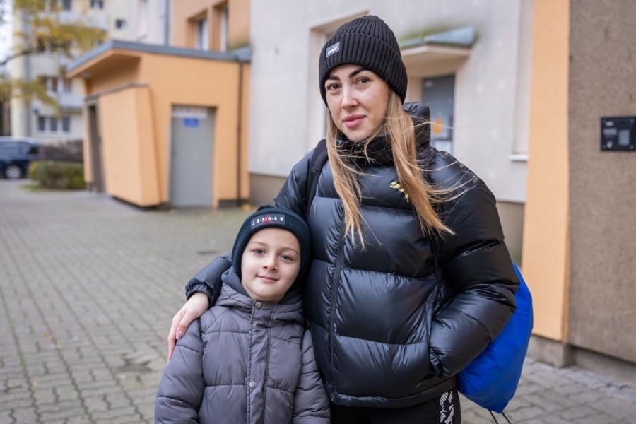 Woman standing with her son. 