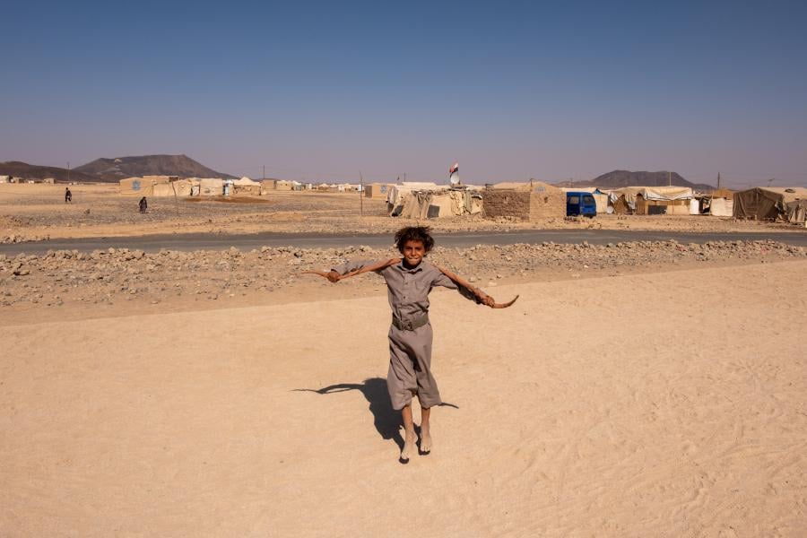 child jumping in the desert