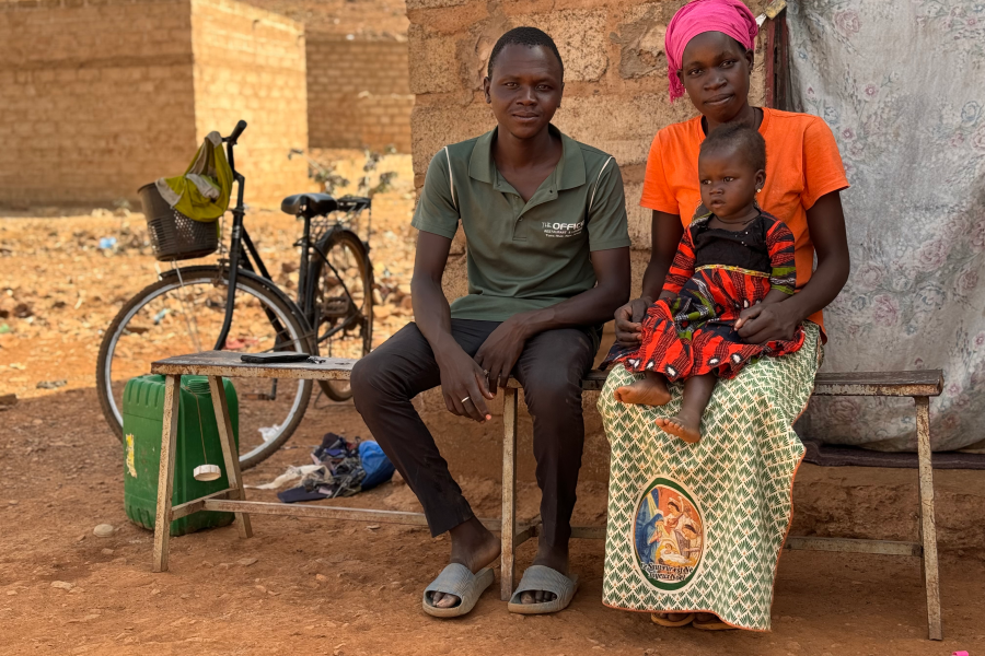 A family sitting in front of their house