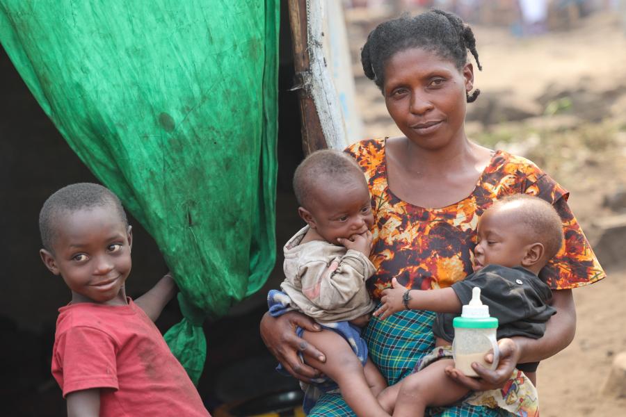 A woman sitting with her babies