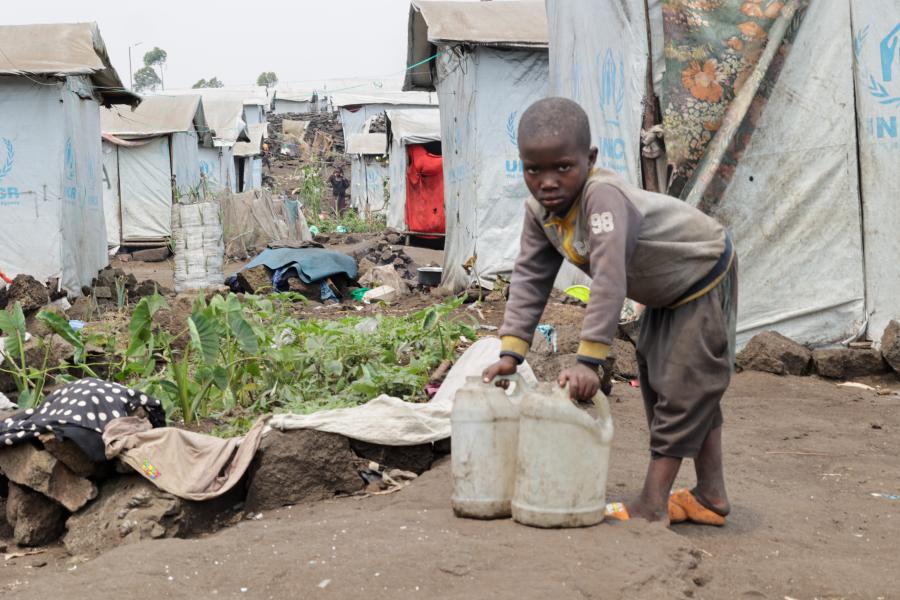 A kid carrying water