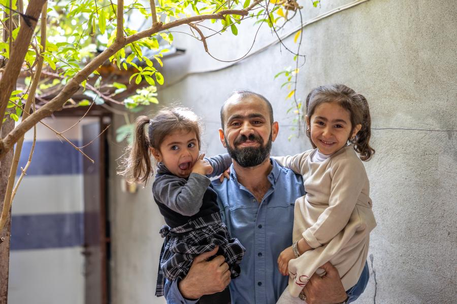 A man carrying his daughters 
