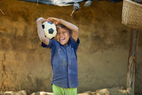 a boy holding a ball 