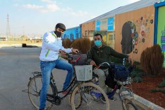 Youssef (left) and Ahmed (right) are pictured outside the innovation lab in Zaatari Camp, Jordan. 