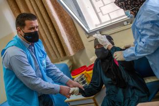 104-year-old Aisha Khalil receives COVID-19 vaccine in Jordan. 