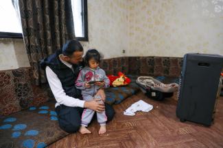 Nizar, 25, a Syrian refugee plays with his daughter Tabarka, 4, at home in Jordan.
