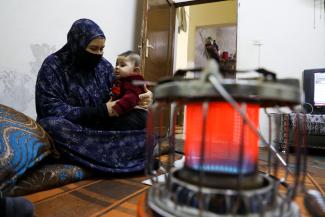 Siham, 43, is pictured with her grandson at home in Amman, Jordan.