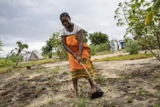 Angelina, 31, works on the piece of land the Government attributed to her and her husband in Mutua settlement.