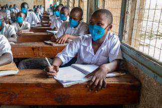 Grade 8 learners at Arid Zone Primary School attend a language lesson while wearing facemasks.