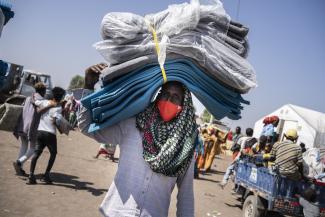 An Ethiopian refugee collects blankets and mattresses at Hamdayet reception centre in Sudan, where days are intensely hot and night-time temperatures plummet..