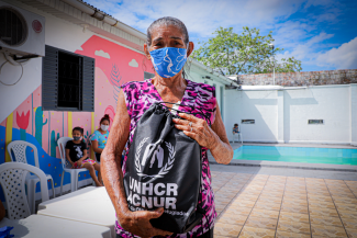 An elderly Venezuelan refugee collects essential items distributed by UNHCR in Manaus, northern Brazil.