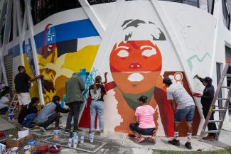  Young artists work on a mural being painted at a community centre in San Salvador supported by UNHCR which provides psychosocial care and humanitarian aid to internally displaced people.