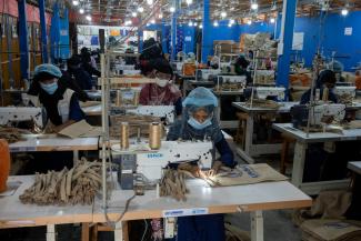 women producing items in a factory