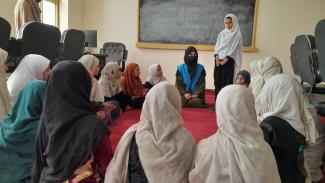 woman teaching to girls 