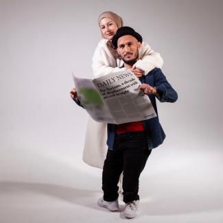 woman and man reading newspaper