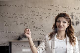 woman writing and smiling