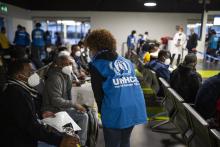 UNHCR staff greeting asylum-seekers at the airport